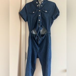 A blue Jean jumpsuit with a tie